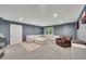 Cozy living room area with a white sectional sofa and leather recliner at 320 Ironhill Trce, Woodstock, GA 30189