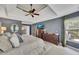 Inviting main bedroom with neutral carpet, tray ceiling, and dark blue accent walls at 320 Ironhill Trce, Woodstock, GA 30189