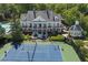 Back of house with balcony overlooking the tennis court and community pool with gazebo at 320 Ironhill Trce, Woodstock, GA 30189