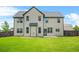 Well-maintained backyard with lush green grass and a view of the home's rear elevation at 321 Shannon Ct, Mcdonough, GA 30252