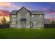 A spacious backyard features a well-maintained lawn, privacy fence, and the rear facade of a two-story house at 321 Shannon Ct, Mcdonough, GA 30252