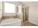 Bathroom features a tub and separate shower at 321 Shannon Ct, Mcdonough, GA 30252
