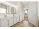 Bathroom featuring a double vanity with ample counter space and a view into an adjoining room at 321 Shannon Ct, Mcdonough, GA 30252
