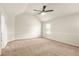 A large room with beige carpet, featuring high ceiling and bright window at 321 Shannon Ct, Mcdonough, GA 30252