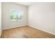 Sunlit bedroom with hardwood floors, natural light, and neutral walls at 321 Shannon Ct, Mcdonough, GA 30252