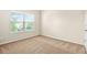 Bright bedroom with a large window offering natural light and neutral carpeting at 321 Shannon Ct, Mcdonough, GA 30252