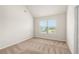 Bedroom with a large window, neutral carpeting, and ample natural light at 321 Shannon Ct, Mcdonough, GA 30252