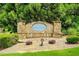A stone sign that reads Lake Iris at King Mill is surrounded by lush landscaping at 321 Shannon Ct, Mcdonough, GA 30252