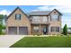 Beautiful two-story brick home with a manicured lawn and a two-car garage at 321 Shannon Ct, Mcdonough, GA 30252