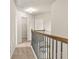 Upstairs hallway features neutral walls, carpet, and iron railing at 321 Shannon Ct, Mcdonough, GA 30252