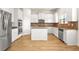 Well-lit kitchen features white cabinets, stainless steel appliances and granite countertops at 321 Shannon Ct, Mcdonough, GA 30252