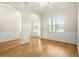 Bright living room featuring hardwood floors, wainscoting and an arched entryway at 321 Shannon Ct, Mcdonough, GA 30252