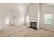 Bright living room with vaulted ceiling, neutral carpet, and fireplace at 321 Shannon Ct, Mcdonough, GA 30252