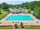 Aerial view of the community pool with seating and surrounding green space at 321 Shannon Ct, Mcdonough, GA 30252