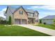 A side view shows the home's brick and siding, with a manicured lawn and a two-car garage at 321 Shannon Ct, Mcdonough, GA 30252