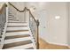 Staircase showcases wood treads, white risers, and wrought iron spindles at 321 Shannon Ct, Mcdonough, GA 30252