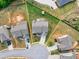 A well-maintained house with manicured lawn, bordered in yellow lines, surrounded by more houses in an aerial view at 3302 Avenel Ct, Snellville, GA 30078