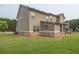 Exterior shot of backyard featuring well-manicured grass and an enclosed porch area at 3302 Avenel Ct, Snellville, GA 30078