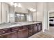 Bathroom with dual sinks, granite counters, and a walk-in shower at 3302 Avenel Ct, Snellville, GA 30078