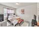 Cozy bedroom with decorative bedding, a window and accent art on the wall at 3302 Avenel Ct, Snellville, GA 30078