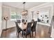 Bright dining room with modern lighting, hardwood floors, and access to other living spaces at 3302 Avenel Ct, Snellville, GA 30078