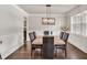 Elegant dining room with hardwood floors, a modern chandelier and large windows at 3302 Avenel Ct, Snellville, GA 30078