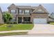 Charming two-story home with a well-manicured lawn and brick and siding exterior at 3302 Avenel Ct, Snellville, GA 30078