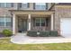 Cozy front porch with seating area, brick accents, and well maintained bushes at 3302 Avenel Ct, Snellville, GA 30078