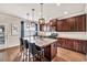 Modern kitchen featuring granite countertops, stainless steel appliances, and dark wood cabinetry at 3302 Avenel Ct, Snellville, GA 30078