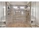 Spacious glass shower with a built-in bench, double shower heads and travertine tiling at 3302 Avenel Ct, Snellville, GA 30078