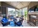 Relaxing sunroom featuring comfortable seating, a fireplace, and views of the backyard at 3302 Avenel Ct, Snellville, GA 30078