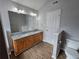 Bathroom features a double sink vanity with wood cabinets, granite countertop, and wood flooring at 4677 Liberty Square Dr, Acworth, GA 30101