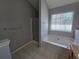 Bright bathroom with a soaking tub next to a window, tiled floors, and a glass-enclosed shower at 4677 Liberty Square Dr, Acworth, GA 30101