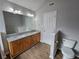 Bathroom features a double sink vanity with wood cabinets, granite countertop, and wood flooring at 4677 Liberty Square Dr, Acworth, GA 30101