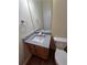 Bathroom featuring granite countertop, sink, and wood cabinetry at 4677 Liberty Square Dr, Acworth, GA 30101