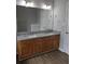 Bathroom features a double sink vanity with wood cabinets, granite countertop, and wood flooring at 4677 Liberty Square Dr, Acworth, GA 30101