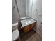 Modern bathroom features a granite countertop, wood cabinetry, and tile flooring at 4677 Liberty Square Dr, Acworth, GA 30101