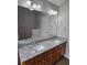 Bright bathroom featuring a double vanity with granite countertop and modern fixtures at 4677 Liberty Square Dr, Acworth, GA 30101