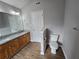 Bathroom features a double sink vanity with wood cabinets, granite countertop, and wood flooring at 4677 Liberty Square Dr, Acworth, GA 30101