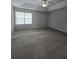 Large bedroom featuring neutral colored walls and carpet with a ceiling fan and natural light at 4677 Liberty Square Dr, Acworth, GA 30101
