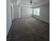 Spacious bedroom featuring a ceiling fan, carpet floors and a large window at 4677 Liberty Square Dr, Acworth, GA 30101