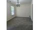 Spacious dining room with a chandelier, one window and neutral walls at 4677 Liberty Square Dr, Acworth, GA 30101