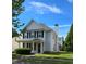Charming two-story home with gray siding, black shutters, a chimney, and a well-manicured lawn on a sunny day at 4677 Liberty Square Dr, Acworth, GA 30101