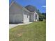 Exterior view of the home showcasing a well-manicured lawn and a two-car attached garage at 4677 Liberty Square Dr, Acworth, GA 30101