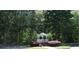 Charming white gazebo surrounded by lush greenery and mature trees in a peaceful community setting at 4677 Liberty Square Dr, Acworth, GA 30101