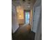 Hallway with neutral carpet and a hanging light fixture, providing access to various rooms at 4677 Liberty Square Dr, Acworth, GA 30101