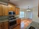 The kitchen features wooden cabinets, granite countertops and stainless steel appliances at 4677 Liberty Square Dr, Acworth, GA 30101