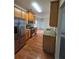 Well-lit kitchen featuring stainless steel appliances, granite countertops, and hardwood floors at 4677 Liberty Square Dr, Acworth, GA 30101
