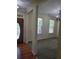 Entryway view of living room featuring gray carpet, windows with blinds, and a modern light fixture at 4677 Liberty Square Dr, Acworth, GA 30101