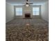 Spacious living room with fireplace, ceiling fan, and neutral carpeting at 4677 Liberty Square Dr, Acworth, GA 30101